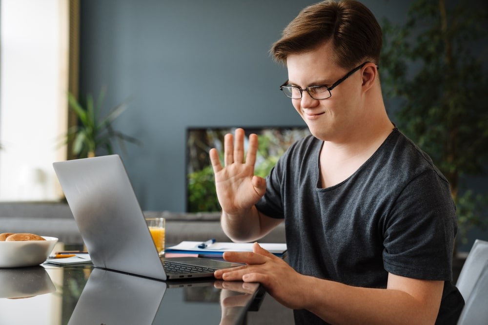 Person Smiling At A Computer