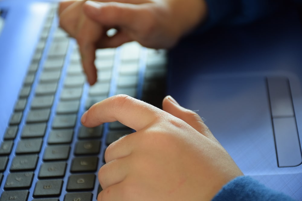 Person Typing On A Keyboard