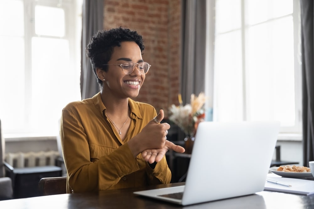 Woman Using A Laptop And Smiling