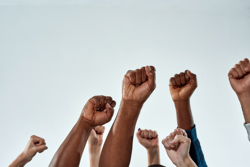 Hands Of Different Colours Are In The Air